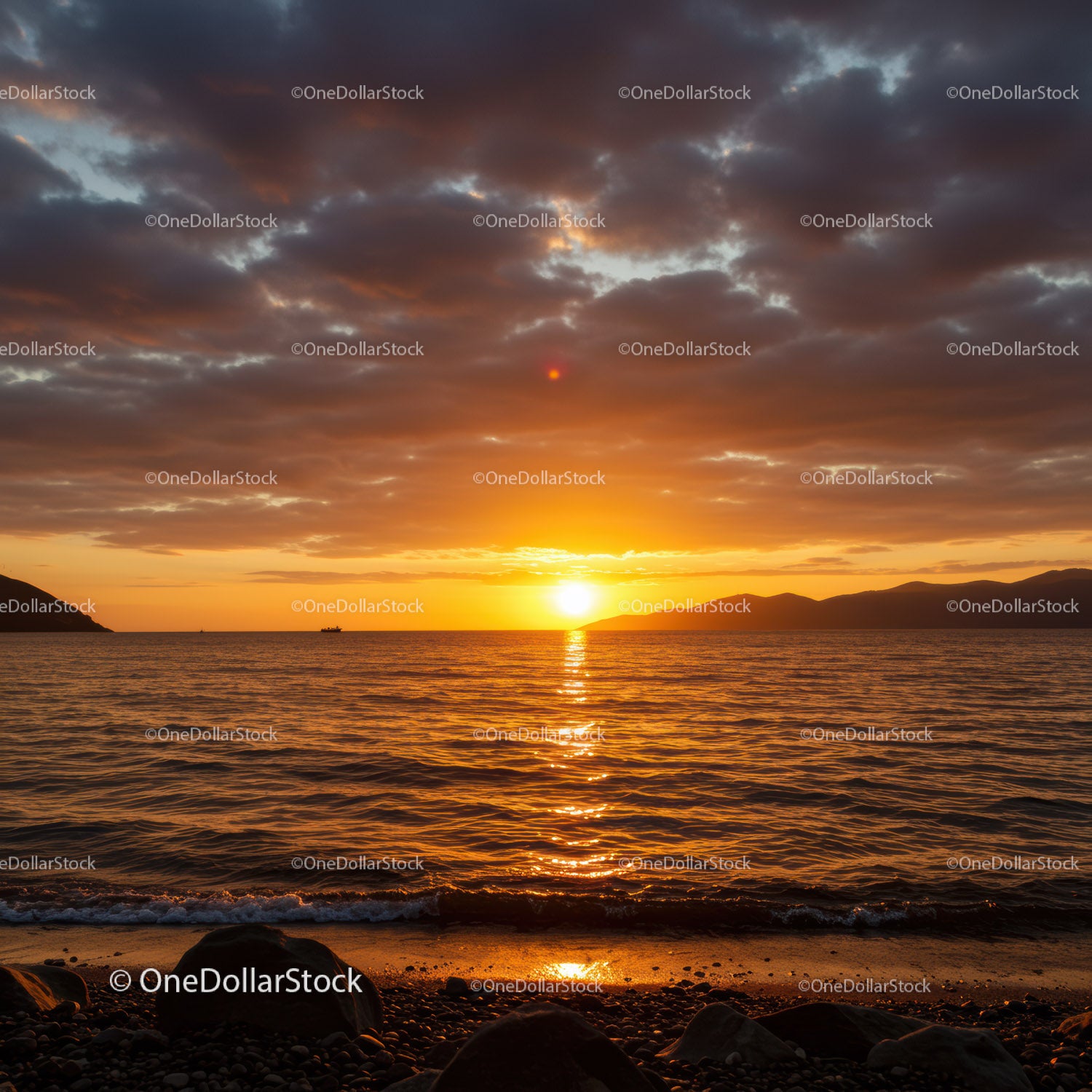 Beautiful Sunset Over Calm Ocean with Rocky Beach and Cloudy Sky