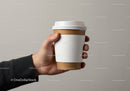 Hand Holding Reusable Coffee Cup with Sleeve