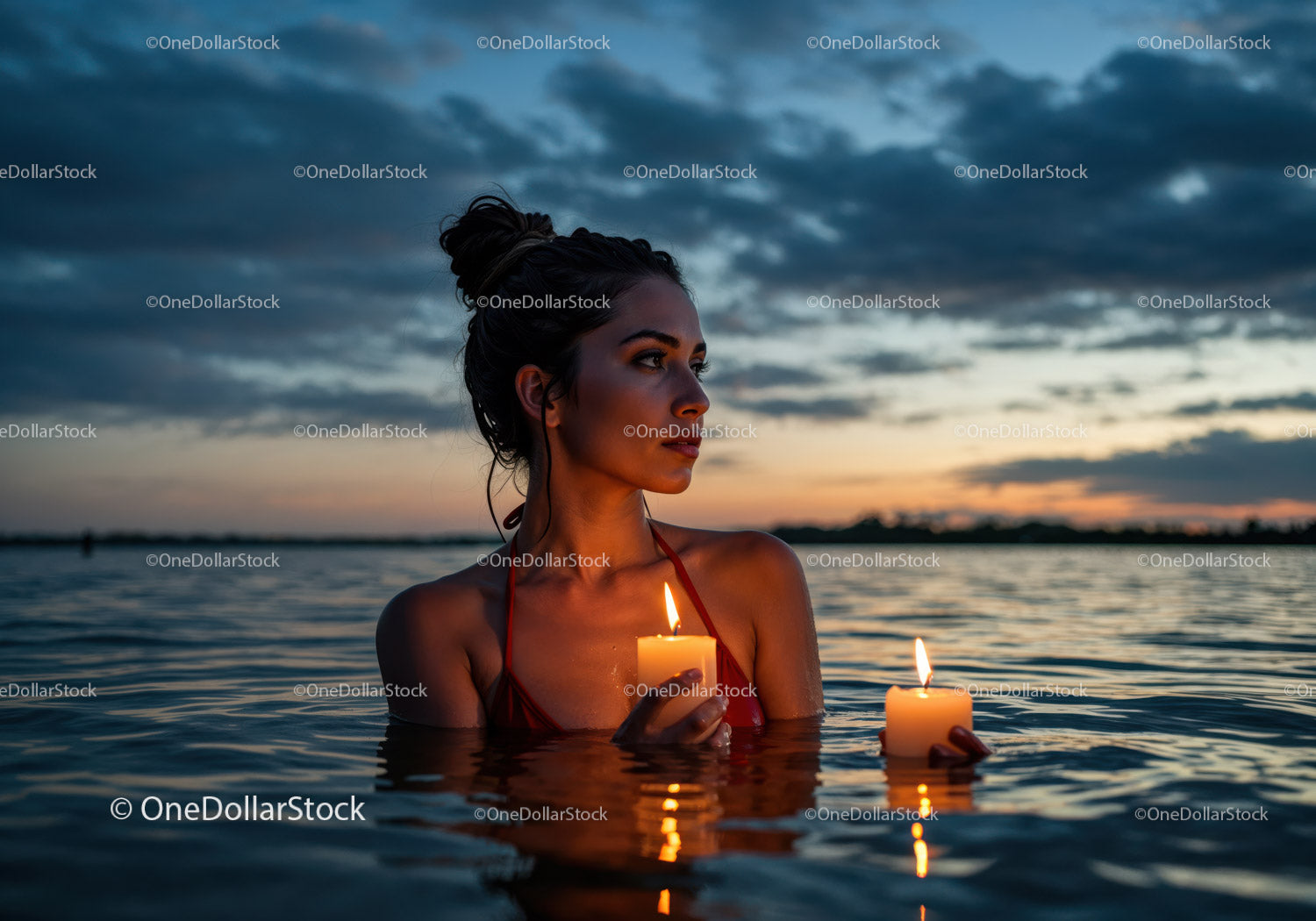 Woman in Black Bikini with Candles Floating in Lake at Sunset