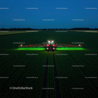 Farm vehicle operating in green fields at night