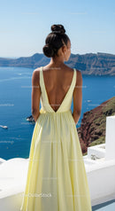 Woman in yellow dress enjoying ocean view on cliffside