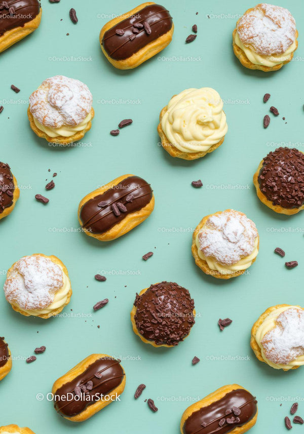 Assorted cream and chocolate pastries on pastel background