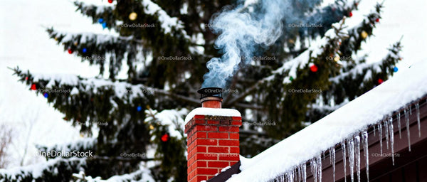 Smoke rising from snow-covered red brick chimney in winter