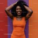 Joyful African American Woman in Vibrant Orange Dress Against Colorful Background