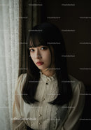 Elegant Woman in Lace Blouse Looking Thoughtfully Near Window