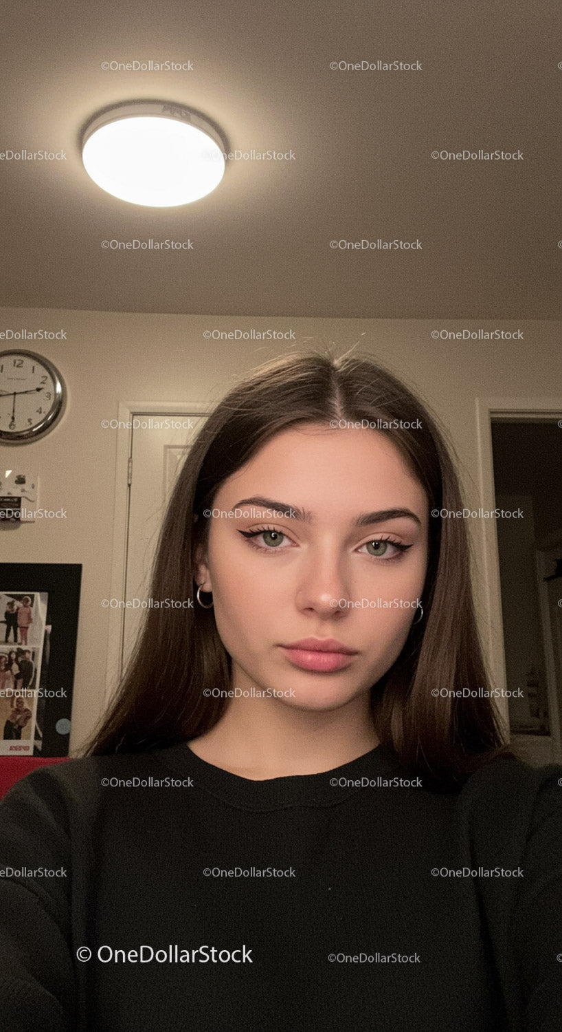 Young woman taking a selfie indoors