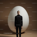 Calm man standing in front of giant white egg