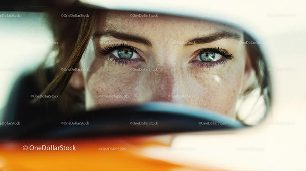 Close-Up of Woman with Bright Blue Eyes and Freckles in Sunlight