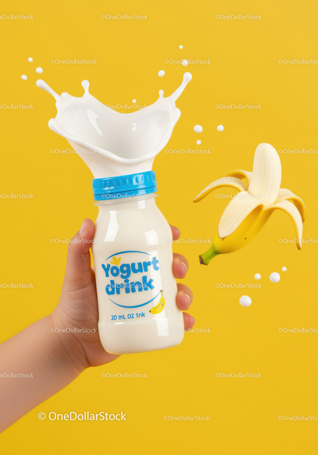 Hand Holding Yogurt Drink with Splash and Banana