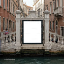 Historic Venetian canal with white marble bridge and gondolier