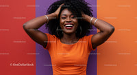 Joyful Black Woman with Curly Hair in Bright Orange Top Against Colorful Wall