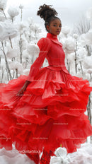 Elegant Woman in Red Dress Amid White Cotton Flowers Outdoors