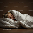 Peaceful child sleeping wrapped in cozy white bedding