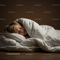 Peaceful child sleeping wrapped in cozy white bedding