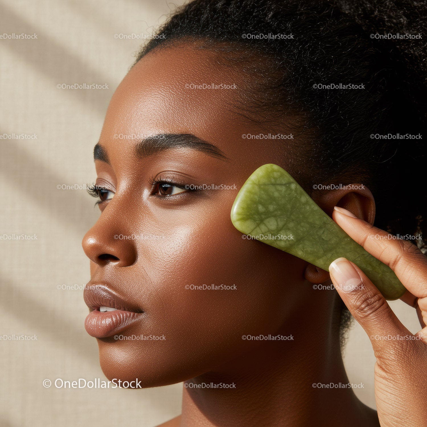 Close Up of Black Woman Using Jade Roller for Facial Massage