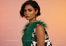 Young Woman with Short Wavy Hair in Green Feathered Top and Cow Print Bag
