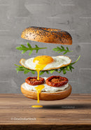 Deconstructed bagel sandwich with fried egg and sun dried tomatoes