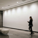 Blurred woman walking in modern minimalistic lobby