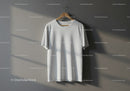 Plain white t-shirt hanging on wooden hanger indoors