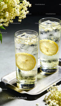 Refreshing elderflower lemon soda with ice cubes