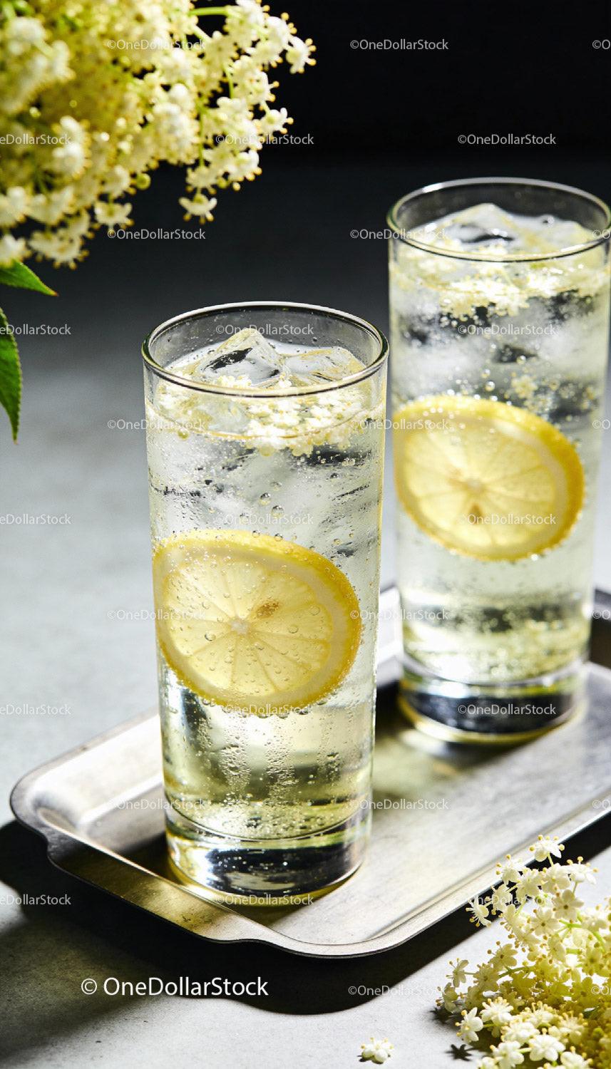 Refreshing elderflower lemon soda with ice cubes