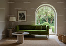 Minimalist living room with green velvet sofa and garden view