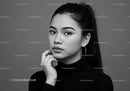 Elegant Black and White Portrait of Confident Young Woman with Hoop Earrings