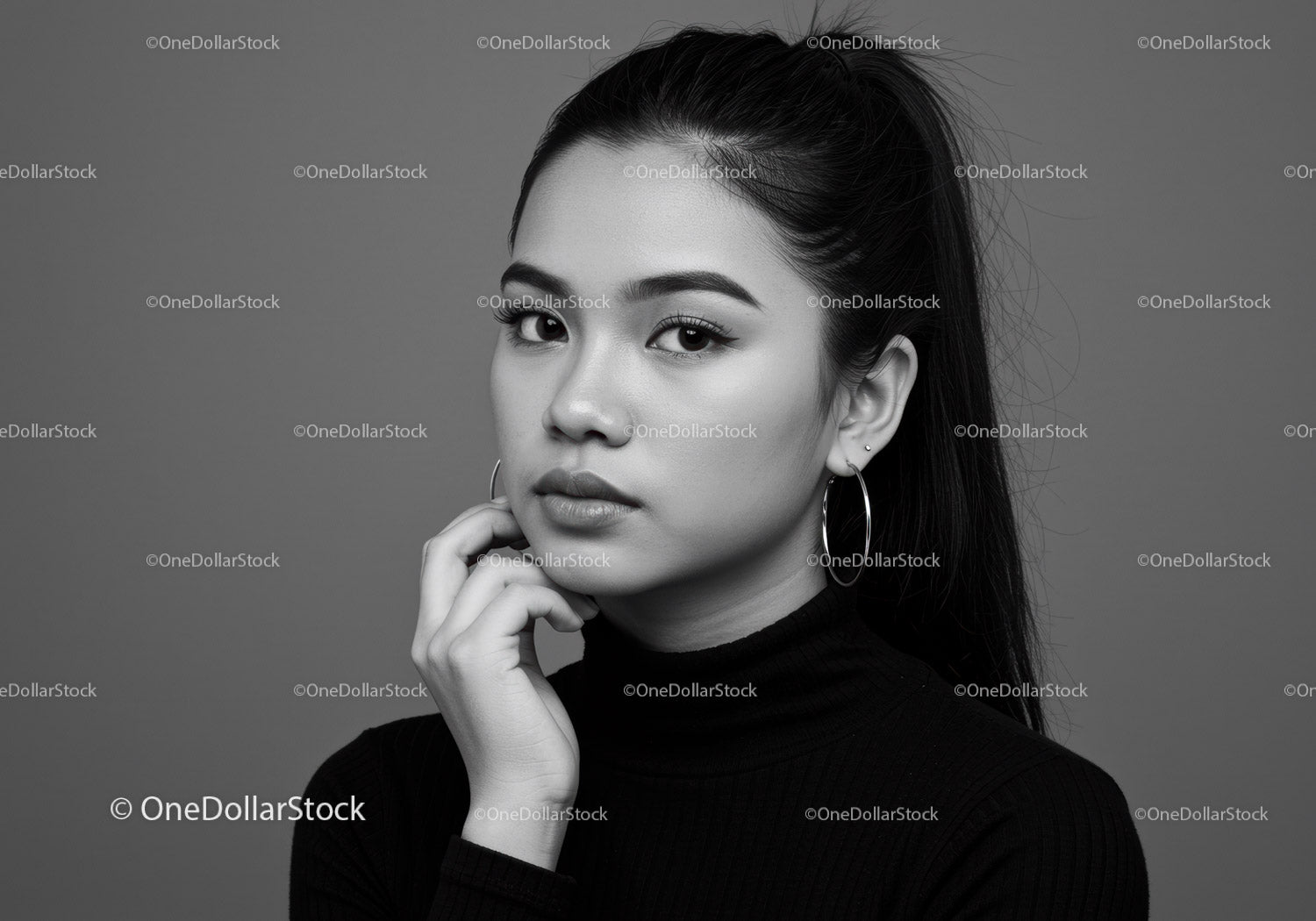 Elegant Black and White Portrait of Confident Young Woman with Hoop Earrings