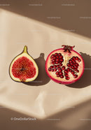 Cut fig and pomegranate on soft beige surface