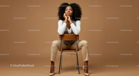 Elegant Woman Seated in Contemplation Against a Brown Background
