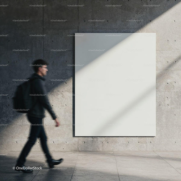 Man walking past empty modern concrete wall with blank canvas JPG Mockup Image