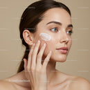 Portrait of a Young Woman Applying Face Cream for Skincare Routine