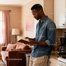 Man calmly reading book in warm cozy kitchen