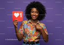 Joyful Young Woman Holding Social Media Like Icon in Bright Purple Background