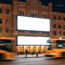 Urban street with illuminated blank billboards at night