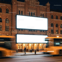 Urban street with illuminated blank billboards at night
