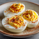 Deviled Eggs with Paprika and Chives on a Rustic Plate