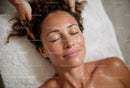 Relaxing Woman Receiving Facial Massage in Spa Luxurious Therapy