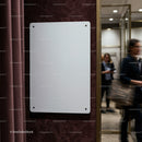 Blank white signboard on textured interior wall
