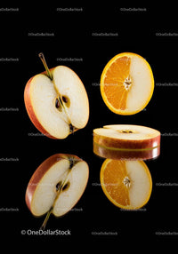 Sliced apple and orange halves on black background