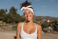 Joyful Young Woman Outdoor Portrait with Bright Smile and Sunny Landscape
