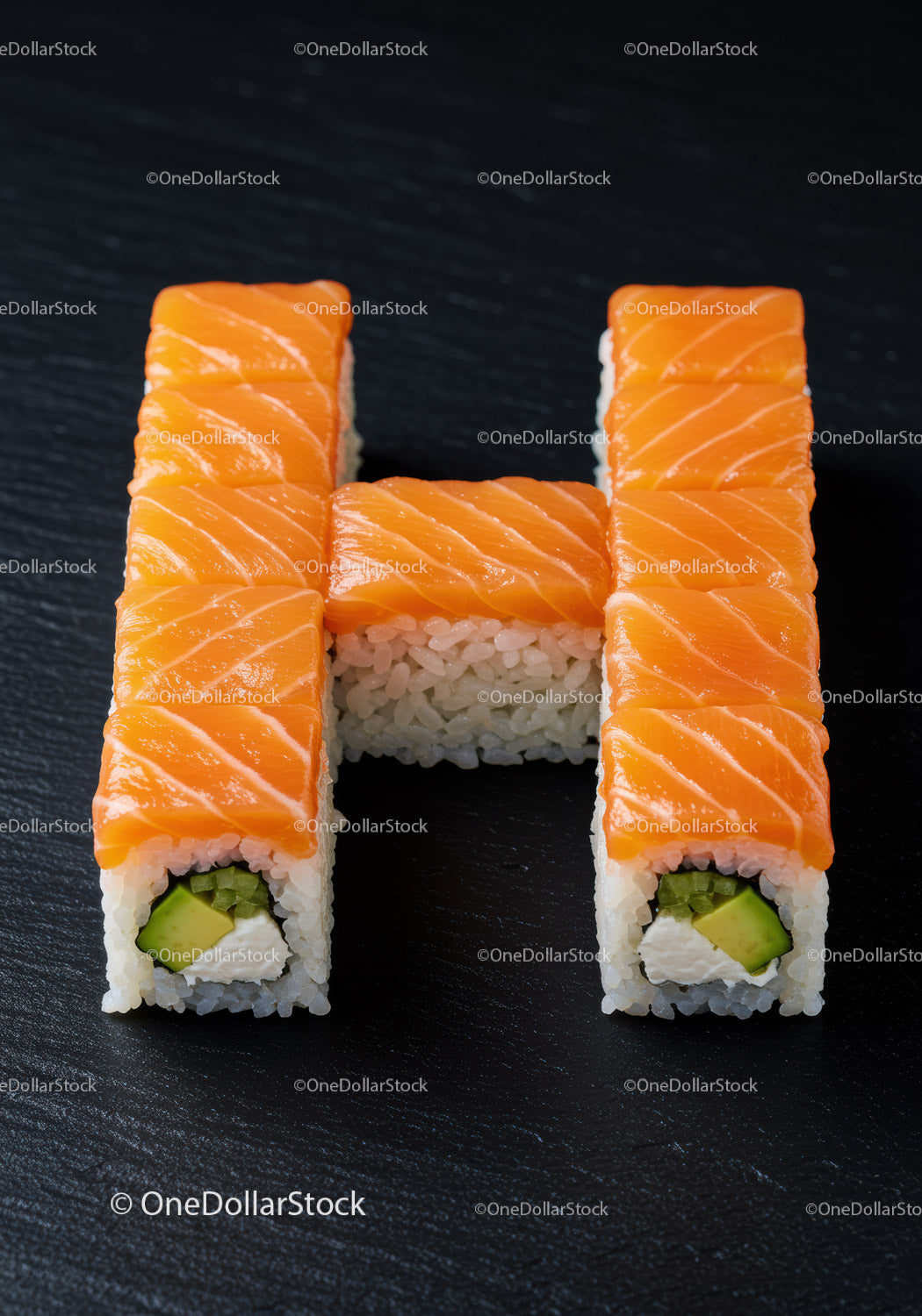Creative salmon sushi rolls arranged in letter H shape