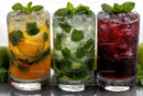 Colorful Iced Fruit Drinks with Citrus and Mint on White Background