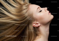 Blonde woman with flowing hair against black background