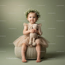 Toddler girl with flower crown holding plush bunny toy