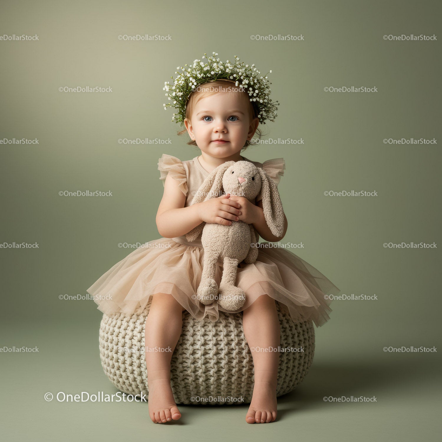 Toddler girl with flower crown holding plush bunny toy