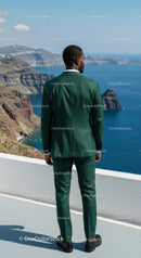 Man in green suit overlooking coastal cliffs and ocean