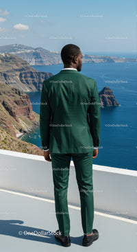 Man in green suit overlooking coastal cliffs and ocean