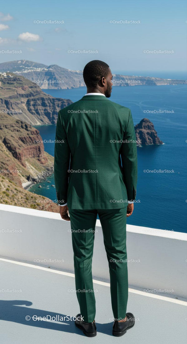 Man in green suit overlooking coastal cliffs and ocean