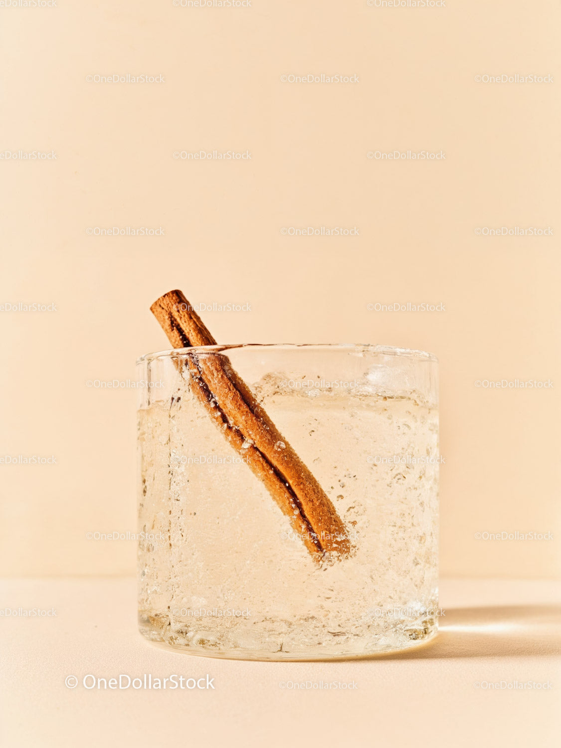 Refreshing clear drink with cinnamon stick in glass
